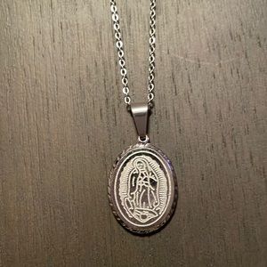 Religious pendant on a silver colour chain